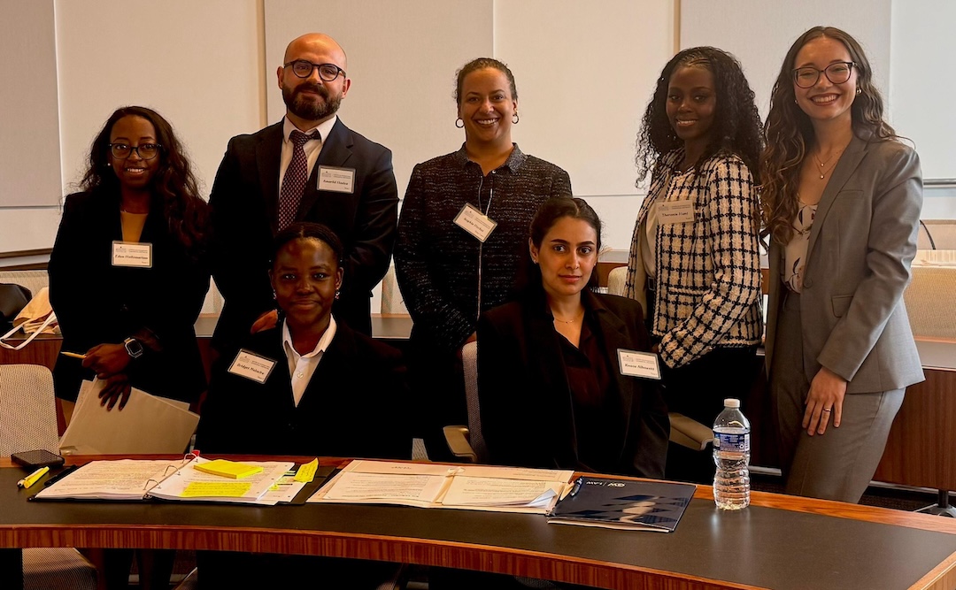 GW Law LLM students pose for a photo after advancing in the Washington Arbitration Competition.